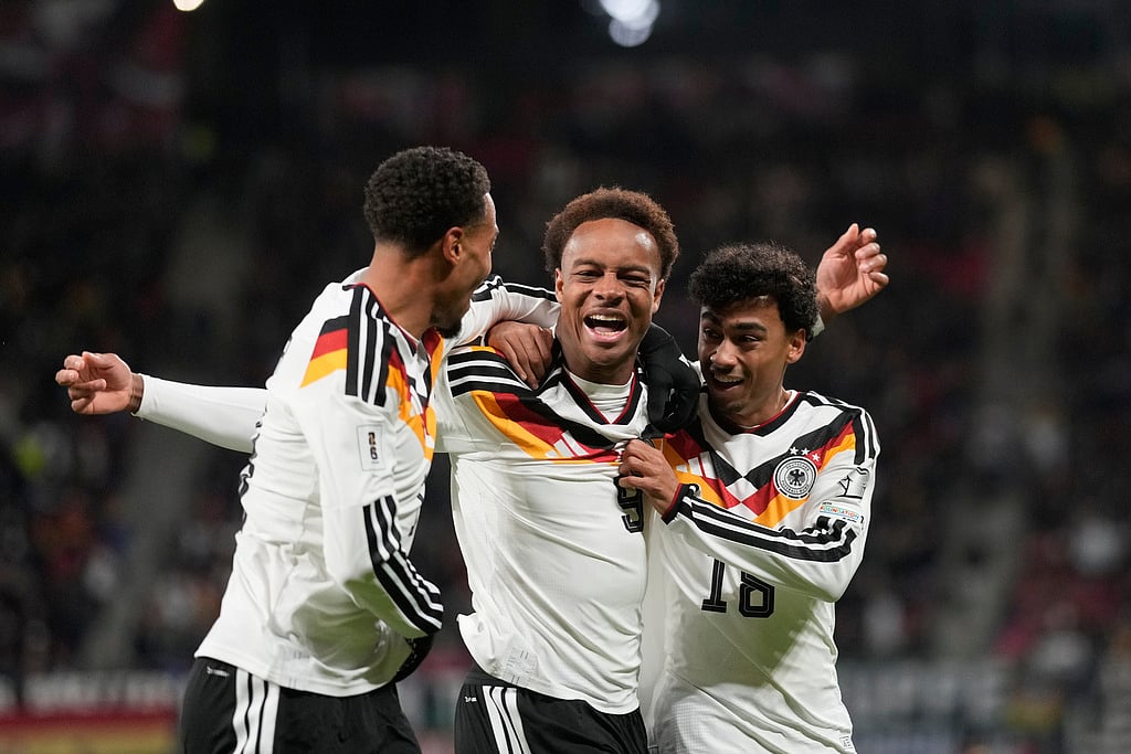 Germany's Assan Ouedraogo, center, celebrates after scoring during a group A World Cup qualifiying soccer match between Germany and Slovakia in Leipzig, Germany, Monday, Nov. 17, 2025. (AP Photo/Matthias Schrader)