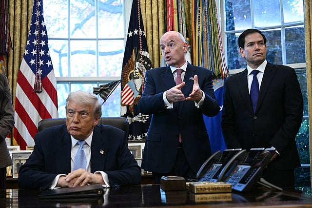 FIFA president Gianni Infantino (C) speaks as US President Donald Trump and the Secretary of State Marco Rubio (R) listen during a meeting with the White House Task Force on the FIFA World Cup 2026 in the Oval Office of the White House in Washington, DC on November 17, 2025.