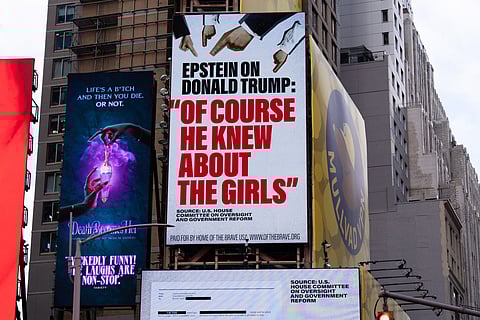 A billboard in Times Square, paid for by the group Home of the Brave, highlights Jeffrey Epstein's comment that Donald Trump "of course he knew about the girls", on November 17, 2025 in New York City.