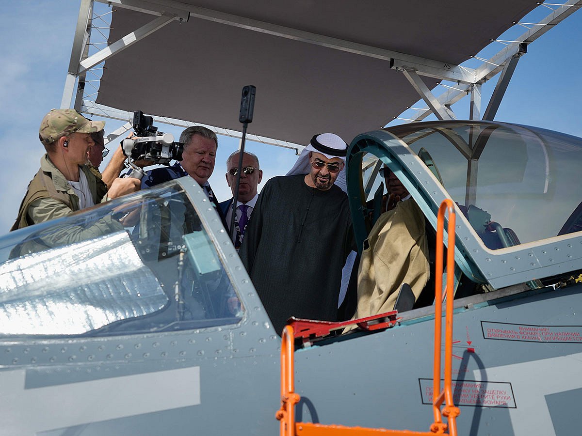 Sheikh Mohamed bin Zayed Al Nahyan checks the cockpit of Russia's SU57E fighter jet at Russian pavilion during the opening day of the Dubai Air Show.