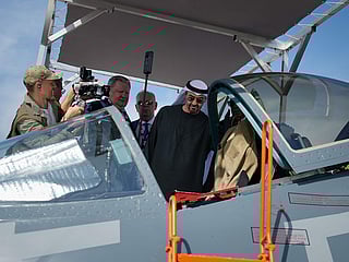Sheikh Mohamed bin Zayed Al Nahyan checks the cockpit of Russia's SU57E fighter jet at Russian pavilion during the opening day of the Dubai Air Show.