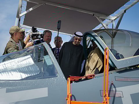 Sheikh Mohamed bin Zayed Al Nahyan checks the cockpit of Russia's SU57E fighter jet at Russian pavilion during the opening day of the Dubai Air Show.