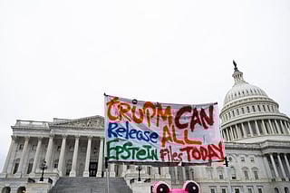 A protester holds a placard after the House voted 427-1 to approve the Epstein Files Transparency Act and the release of documents and files at the U.S. Capitol on November 18, 2025 in Washington, DC. The legislation instructs the U.S. Department of Justice to release all files related to the late accused sex trafficker Jeffrey Epstein.