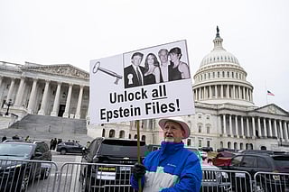 A protester holds a placard after the House voted 427-1 to approve the Epstein Files Transparency Act and the release of documents and files at the U.S. Capitol on November 18, 2025 in Washington, DC. The legislation instructs the U.S. Department of Justice to release all files related to the late accused sex trafficker Jeffrey Epstein.