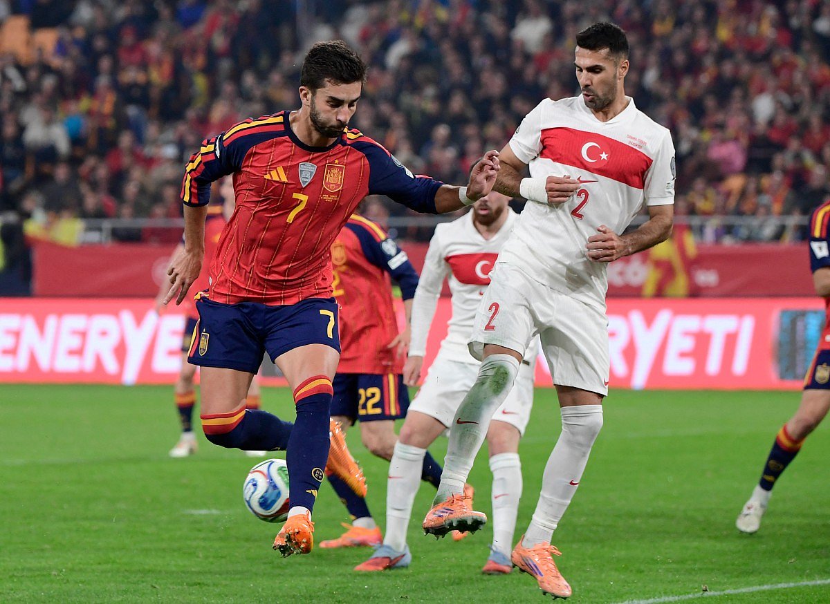 Spain's forward #07 Ferran Torres fights for the ball with Turkey's defender #02 Zeki Celik during the FIFA World Cup 2026 European qualification Group E football match between Spain and Turkey at the Cartuja stadium in Seville on November 18, 2025.