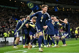 Scotland's midfielder Scott McTominay grabs the corner flag as Scotland's midfielder 23 Kenny McLean celebrates with teammates after scoring his long-range last-kick of the game goal during the Fifa World Cup 2026 European qualification football match against Denmark at Hampden Park in Glasgow on November 18, 2025.