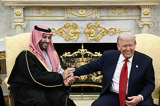 Trump jokes about hand shakes and fist pumps as he meets with Mohammed bin Salman in the Oval Office of the White House in Washington, DC on November 18, 2025.  
