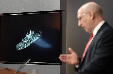 Britain's Defence Secretary John Healey, backdropped by a screen displaying an image of Russian military ship Yantar, operating off the northern coast of Scotland, delivers a speech in the Downing Street briefing room in central London on November 19, 2025.
