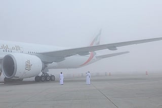Participants at the Dubai Airshow amid dense fog. 