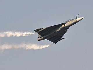 Indian Air Force's HAL Tejas performs is performing a display flight at Al-Maktoum International Airport during the Dubai Airshow 2025 in Dubai on November 20, 2025. 