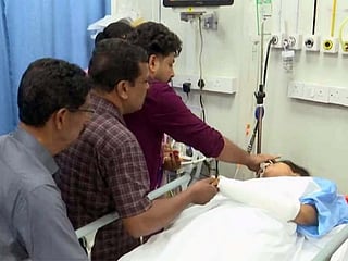 Sharon applies sindoor (vermilion wedding mark) to bride Avani during their heartfelt hospital wedding in Kochi, held after she was injured in a morning road accident.