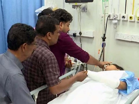 Sharon applies sindoor (vermilion wedding mark) to bride Avani during their heartfelt hospital wedding in Kochi, held after she was injured in a morning road accident.