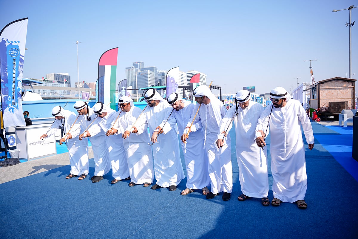 Emirati traditional dancers welcome visitors at the Abu Dhabi International Boat Show, showcasing the UAE’s rich cultural heritage.