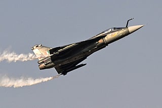 This photograph taken on November 20, 2025 shows an Indian Air Force HAL Tejas fighter jet, which crashed the following day, performing a flying display at Al-Maktoum International Airport during the Dubai Airshow 2025 in Dubai.
