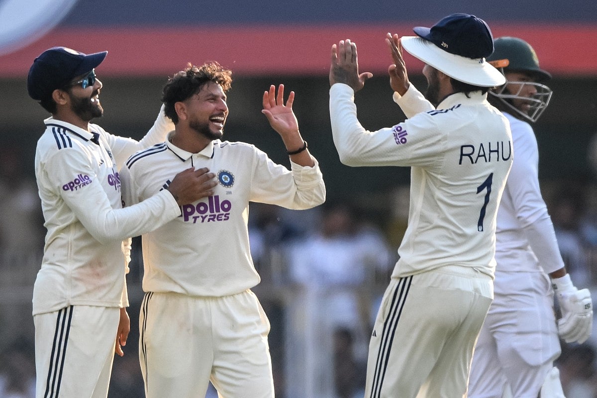 India's Kuldeep Yadav (C) celebrates with teammates after taking the wicket of South Africa's Wiaan Mulder during the first day of the second Test match at the Barsapara Cricket Stadium in Guwahati on November 22, 2025.