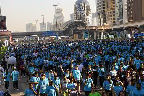 Tens of thousands flood Sheikh Zayed Road at sunrise, turning it into a vibrant river of colour and movement for Dubai Run 2025.