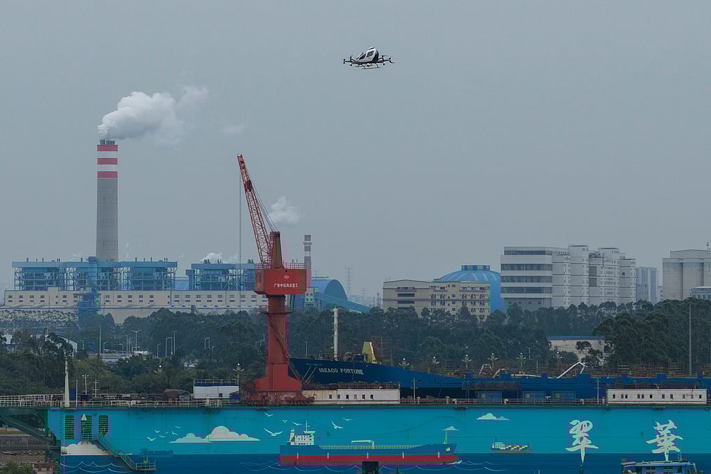 The EHang eVTOL EH126-S takes to the sky over a port in Guangzhou in southern China's Guangdong province on Monday, Nov. 3, 2025.