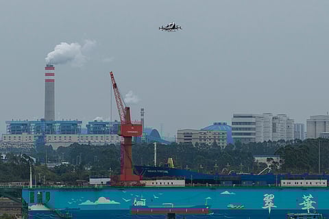 The EHang eVTOL EH126-S takes to the sky over a port in Guangzhou in southern China's Guangdong province on Monday, Nov. 3, 2025.
