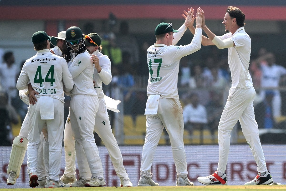 South Africa's Marco Jansen (R) celebrates with teammates after taking the wicket of Nitish Kumar Reddy during the third day of the second Test cricket match against India at the Barsapara Cricket Stadium in Guwahati on November 24, 2025.