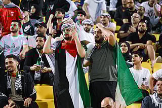 Fans react during the FIFA Arab Cup 2025 play-off football match between Libya and Palestine at Al Gharafa Stadium in Al-Rayyan on November 25, 2025.
