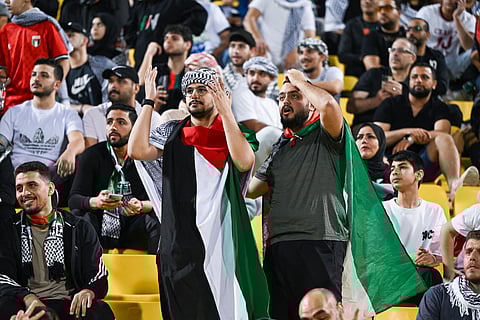 UAE fans cheer during the FIFA World Cup 2026 Asian qualifier football match between United Arab Emirates and Oman at Jassim Bin Hamad Stadium in Doha on October 11, 2025.
