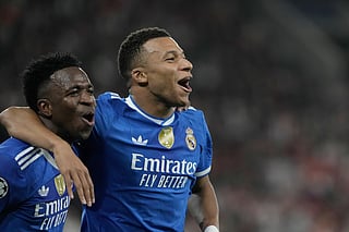 Real Madrid's Kylian Mbappe, right, celebrates with his teammate Vinicius Junior after scoring his side's fourth goal during the Champions League opening phase soccer match between Olympiacos and Real Madrid, in in Piraeus port, near Athens, Greece, Wednesday, Nov. 26, 2025. 
