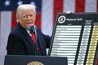 US President Donald Trump holds a chart as he delivers remarks on reciprocal tariffs during an event in the Rose Garden entitled "Make America Wealthy Again" at the White House in Washington, DC, on April 2, 2025.