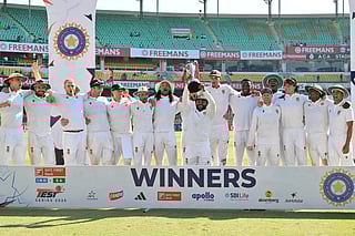 South Africa's players pose with the trophy to celebrate their win in the end of the fifth day of the second Test cricket match against India at the Barsapara Cricket Stadium in Guwahati on November 26, 2025.