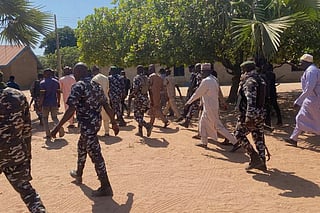 Police and government officials walk past St. Mary's Catholic Primary and Secondary School where gunmen on Friday abducted children and staff in Papiri community, Nigeria. File photo taken on Tuesday, Nov.25, 2025. 