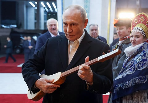 Putin charms Bishkek as he tries Kyrgyz ‘komuz’ during state visit   