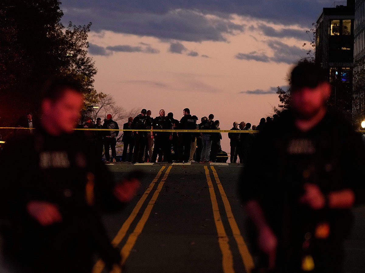 Emergency personnel keep a presence following the shooting of two National Guard soldiers near the White House.