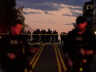 Emergency personnel keep a presence following the shooting of two National Guard soldiers near the White House.
