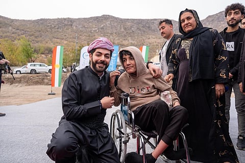 Kurdish businessman and philanthropist Idris Nechirvan Barzani with community members during the launch of solar project.