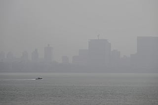 A speedboat is pictured in the Arabian sea amidst smog in Mumbai on November 28, 2025.