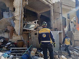 Syrian Civil Defence workers check a house that was destroyed during an Israeli forces raid in the southern Syrian village of Beit Jin, Syria, on Friday, November 28, 2025. 