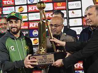 Pakistan's captain Salman Ali Agha (L) holds the trophy during a ceremony at the end of the Twenty20 International Tri-Series final against Sri Lanka at Rawalpindi Cricket Stadium on November 29, 2025.