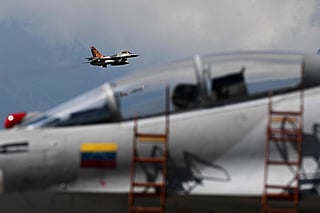 A Venezuelan air force US-made F-16 aircraft overflies during the 2025 Venezuela industrial aviation expo at the Libertador Air Base in Maracay, Aragua State, Venezuela, on November 29, 2025.  