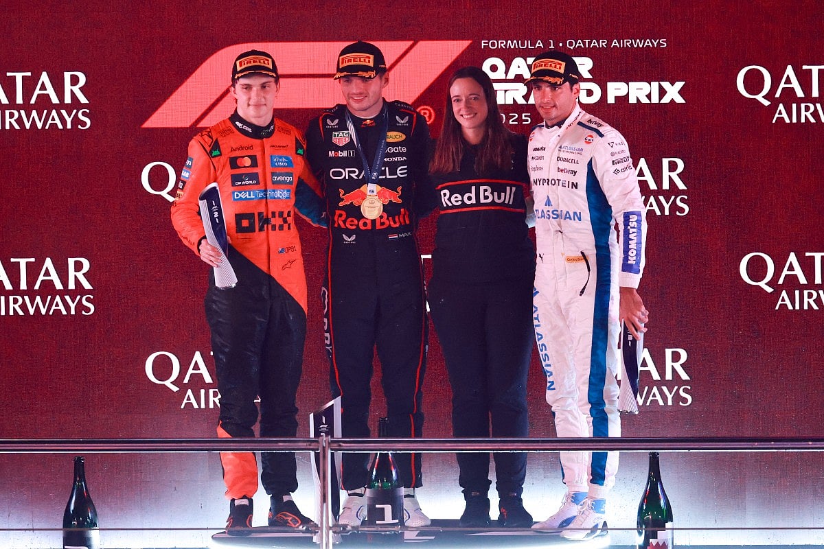 McLaren's Australian driver Oscar Piastri (L), Red Bull Racing's Dutch driver Max Verstappen (2nd-L), Red Bull Racing strategist Hannah Schmitz, (2nd-R) and Williams' Spanish driver Carlos Sainz pose for a picture on the podium after the Formula One Qatar Grand Prix at the Lusail International Circuit in Lusail on November 30, 2025.