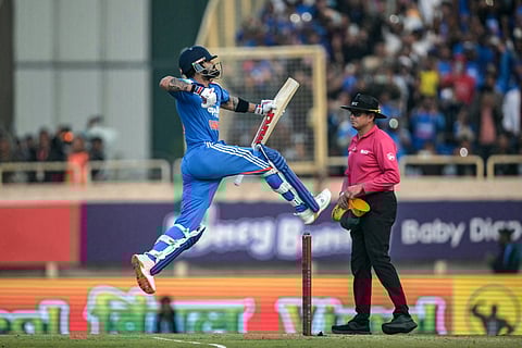 India's Virat Kohli celebrates after scoring a century (100 runs) during the first one-day international (ODI) cricket match between India and South Africa at the JSCA International Stadium in Ranchi on November 30, 2025.