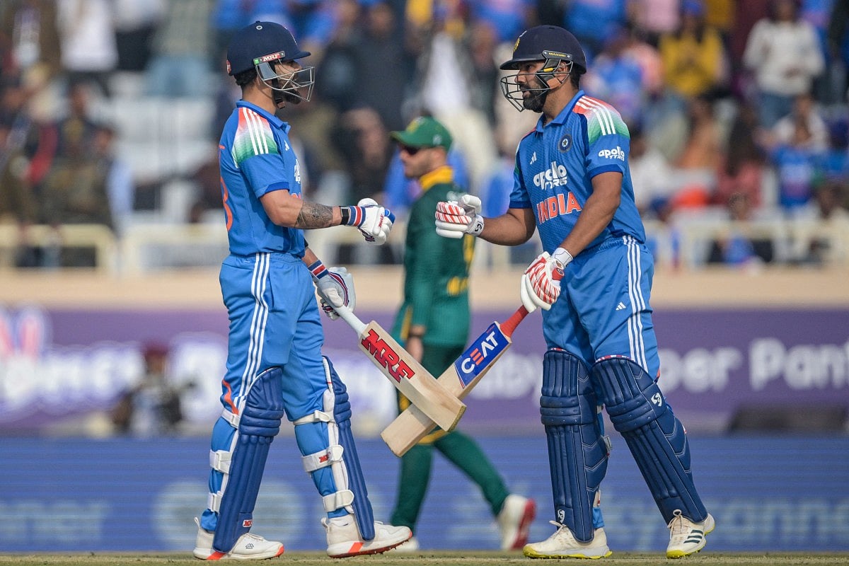 India's Virat Kohli (L) and Rohit Sharma bump their fists during the first one-day international (ODI) cricket match against South Africa at the JSCA International Stadium in Ranchi on November 30, 2025.