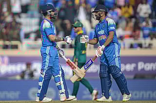 India's Virat Kohli (L) and Rohit Sharma bump their fists during the first one-day international (ODI) cricket match against South Africa at the JSCA International Stadium in Ranchi on November 30, 2025.