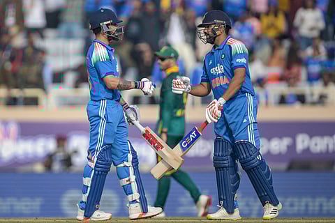 India's Virat Kohli (L) and Rohit Sharma bump their fists during the first one-day international (ODI) cricket match against South Africa at the JSCA International Stadium in Ranchi on November 30, 2025.