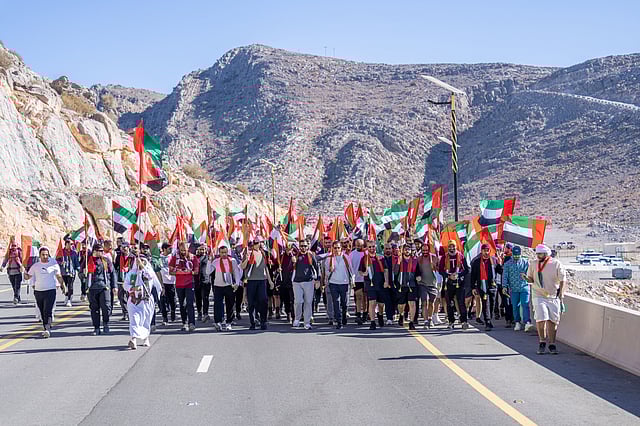 Sheikh Mohammed bin Saud bin Saqr Al Qasimi, Crown Prince of Ras Al Khaimah, joins participants in a mountain walk atop Jebel Jais to celebrate the 54th Union Day, drawing a large turnout across all age groups.