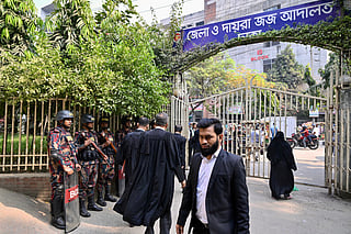 Border Guard Bangladesh (BGB) personnel stand guard outside a court in Dhaka on December 1, 2025.