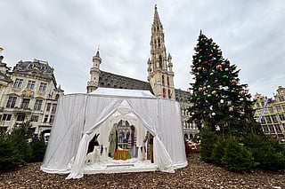 A Nativity scene containing characters with cloth faces, by Belgian artist Victoria-Maria Geyer, is displayed in a white tent in Brussels, Monday, Dec. 1, 2025. (AP Photo/Sylvain Plazy)