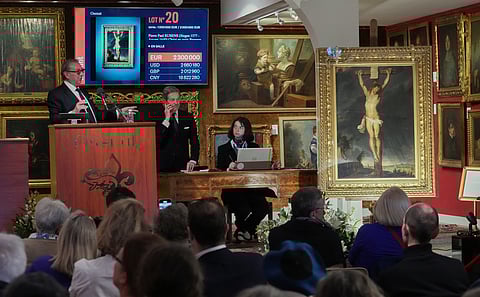 Auction officer Jean-Pierre Osenat gestures as the long-lost painting "Crucifixion of Jesus Christ" by Baroque master Peter Paul Rubens was sold at auction for 2,3 million euros or $2.66 million in Versailles, west of Paris, Nov. 30, 2025. (AP Photo/Michel Euler)