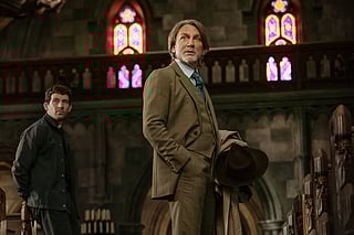 This image released by Netflix shows Josh O'Connor, left, and Daniel Craig in a scene from "Wake Up Dead Man: A Knives Out Mystery." (John Wilson/Netflix via AP)