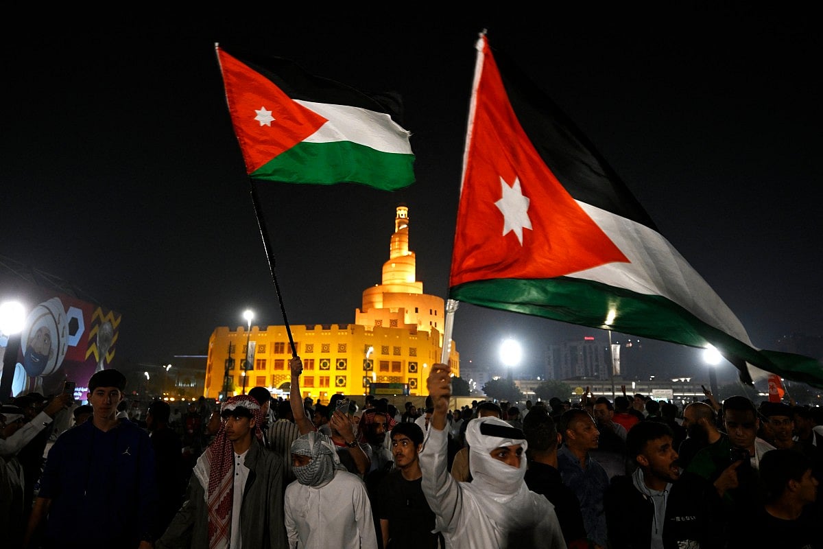 Jordanian supporters celebrate their team's victory in Souq Waqif in Doha on December 3, 2025 after the FIFA Arab Cup 2025 play-off football match between Jordan and UAE. (Photo by Mahmud HAMS / AFP)