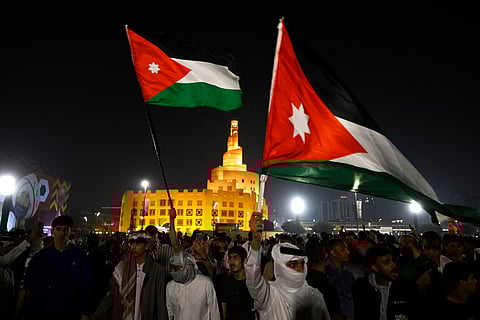 Jordanian supporters celebrate their team's victory in Souq Waqif in Doha on December 3, 2025 after the FIFA Arab Cup 2025 play-off football match between Jordan and UAE. (Photo by Mahmud HAMS / AFP)