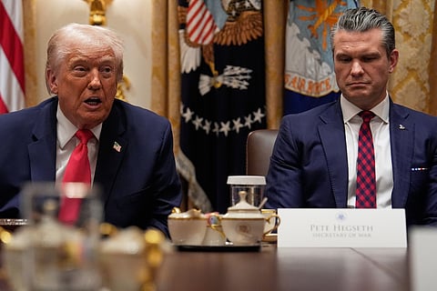 President Donald Trump speaks during a Cabinet meeting at the White House, Tuesday, Dec. 2, 2025, in Washington, as Secretary of Defense Pete Hegseth looks on. (AP Photo/Julia Demaree Nikhinson)